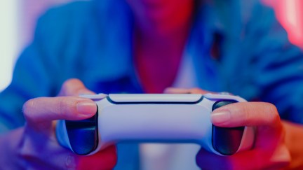 Closeup of hands holding a video game controller.