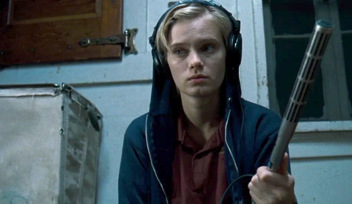 A person wearing headphones looks concerned in The Innkeepers.