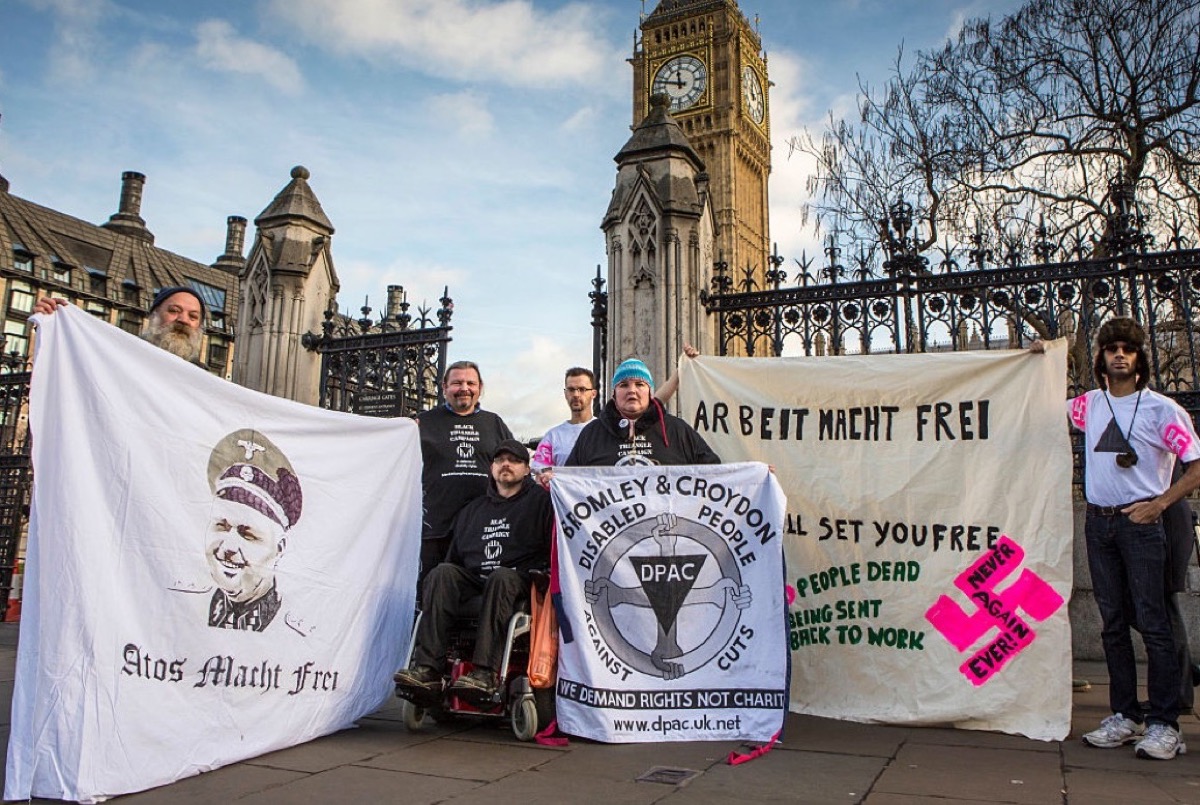 'Disabled People Against the Cuts (DPAC)', 'Black Triangle Campaign' and Never Again Ever!' gather today in outside Parliament to remember the disabled victims of the Nazi Holocaust. The groups want to highlight current injustices such as the 1,300 sick and disabled people who died after being deemed fit to work under this Government's austerity regime. Westminster, London.