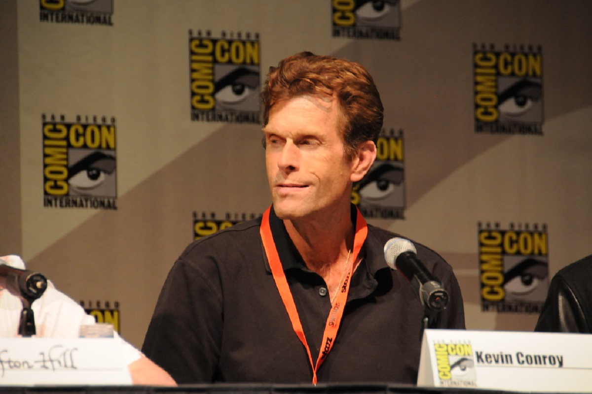 A photo of Kevin Conroy taken during a San Diego Comic Con  panel for the original Batman Arkham Asylum game.
