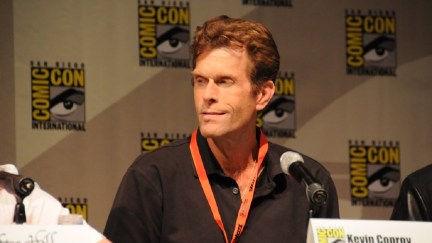 A photo of Kevin Conroy taken during a San Diego Comic Con panel for the original Batman Arkham Asylum game.