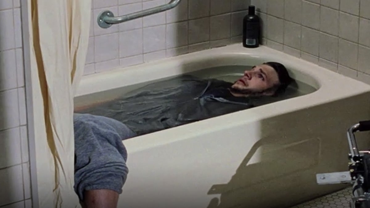 Ashton Kutcher in "The Butterfly Effect" in a bathtub, submerged in the bathwater up to his face.