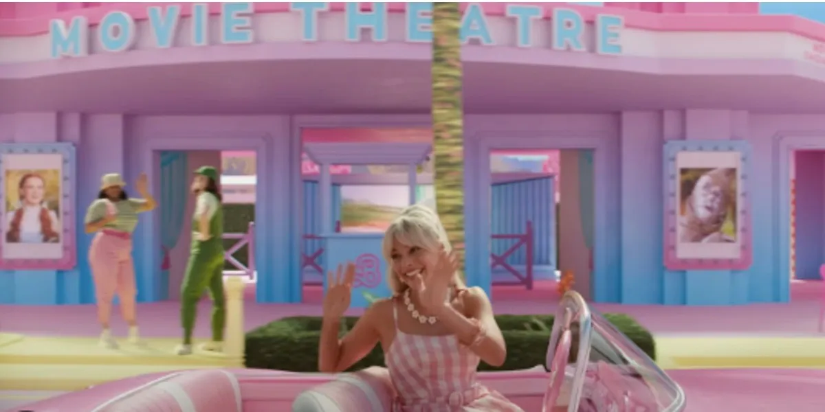 Barbie drives past a theater playing The Wizard of Oz