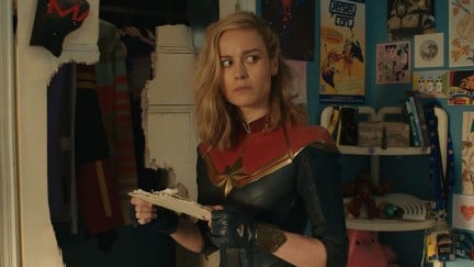 Brie Larson as Captain Marvel, holding a piece of paper and looking confused in Ms. Marvel's post-credits scene