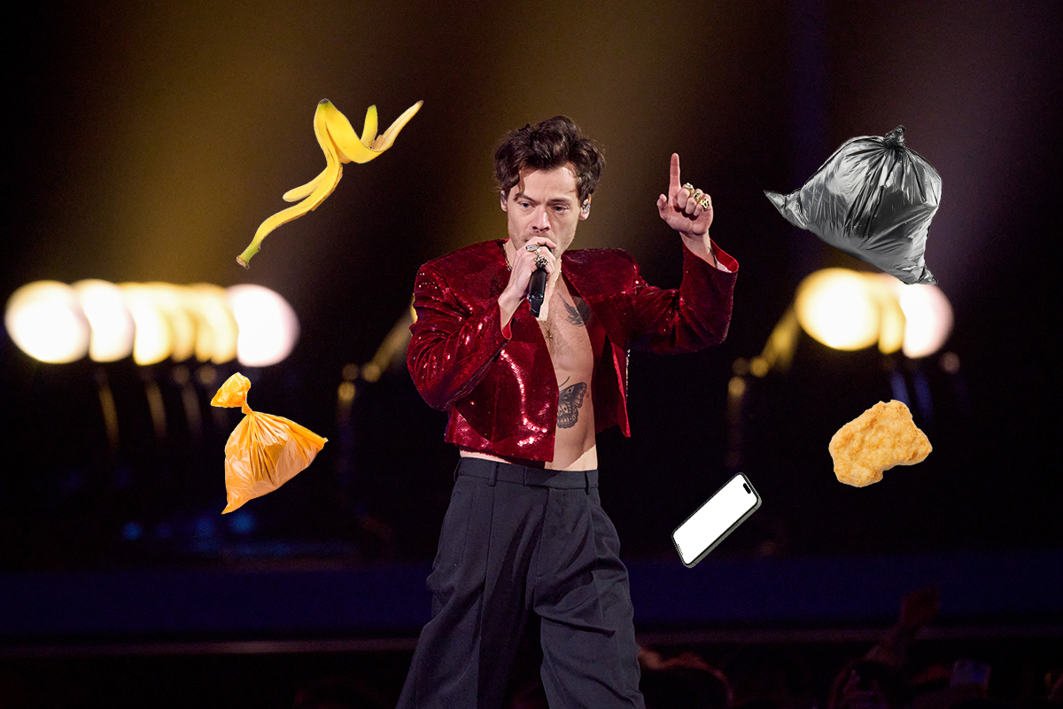 Harry Styles performing at the BRIT Awards with bits of trash being thrown at him