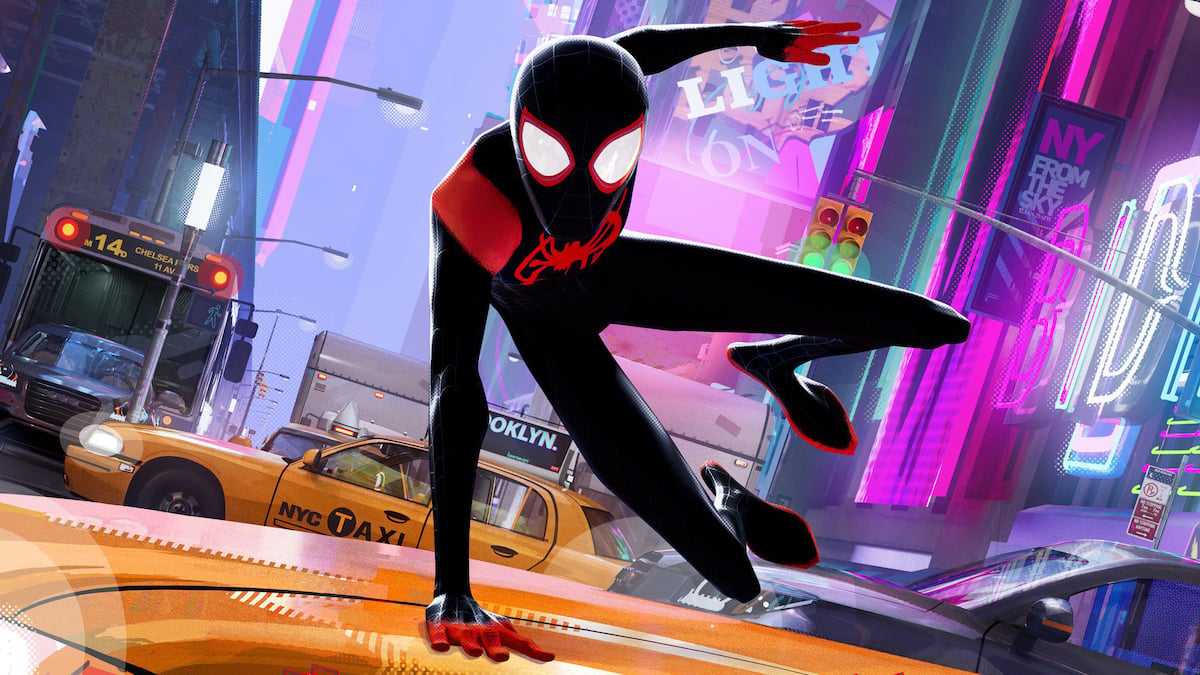 A 3D animated Spider-Man leaping over the hood of a yellow taxi cab on a neon-lighted New York street, in "Into The Spider Verse"