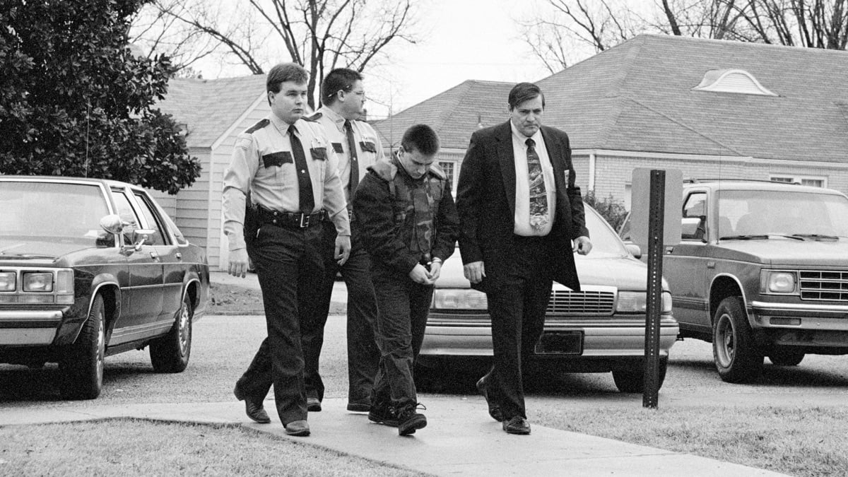 Jessie Misskelley Jr. is led to the courtroom in the custody of police officers, in the documentary 'Paradise Lost.'