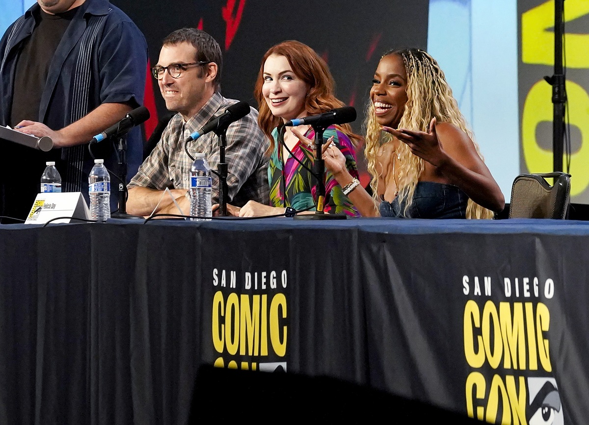 Jonah Ray Rodrigues (white man, glasses, dark hair), Felicia Day (white woman, red hair), and London Hughes (Black woman, long, curly blonde hair) speak onstage during The "Third Eye" Panel at San Diego Comic-Con at Hilton San Diego Bayfront on July 20, 2023 in San Diego, California.