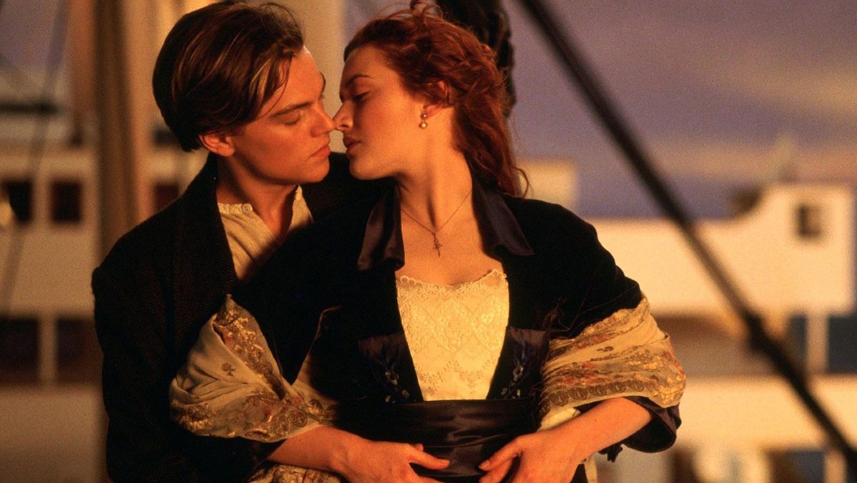Leonardo DiCaprio and Kate Winslet hold each other and nearly share a kiss in "Titanic"