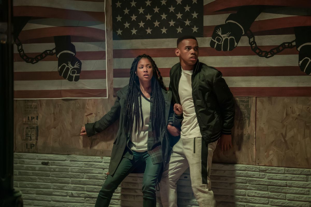 Lex Scott Davis as Nya Charms and Joivan Wade as Isaiah Charms in The First Purge