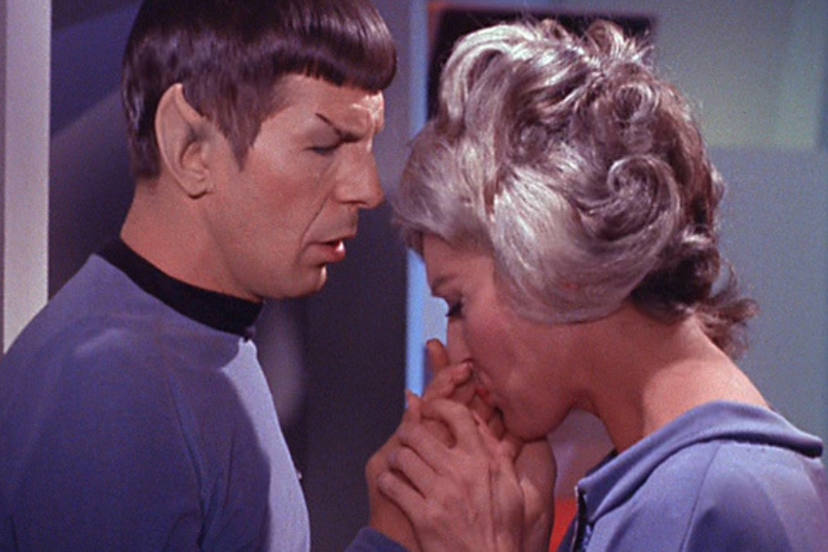 Leonard Nimoy as Spock and Majel Barett as Nurse Chapel in TOS episode "The Naked Time". They're facing each other and she kisses his hand.