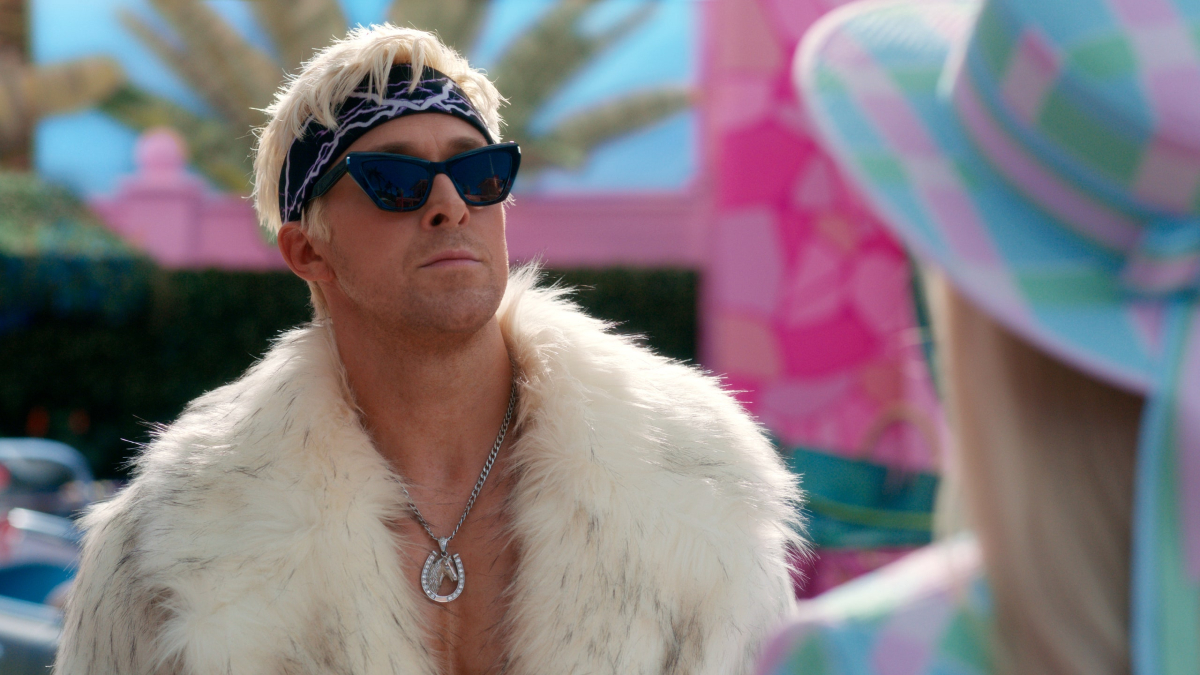Ryan Gosling as Ken in "Barbie" wearing a fur jacket and sunglasses posing smoothly.