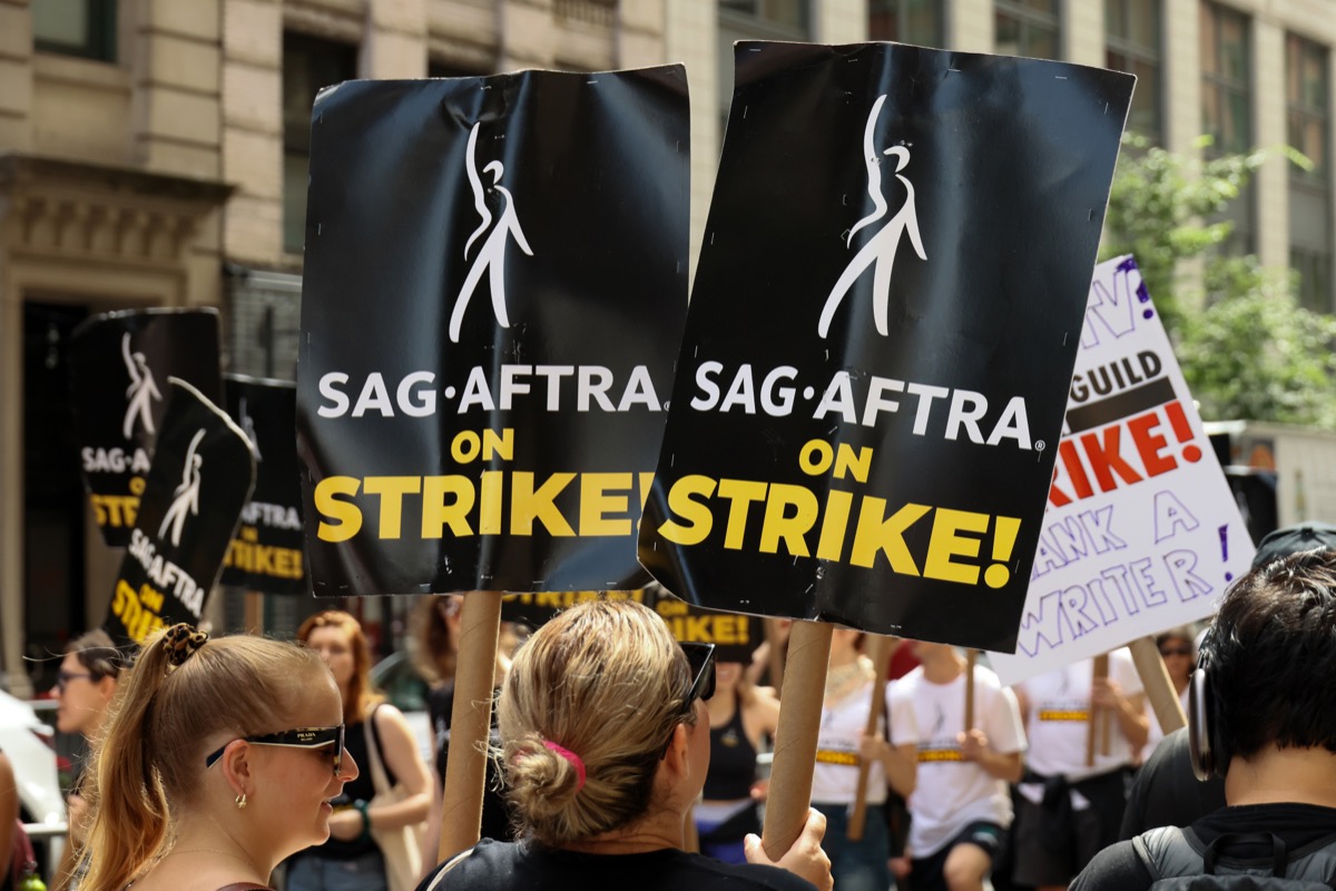 SAG-AFTRA members walk the picket line outside of Netflix and Warner Bros
