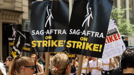SAG-AFTRA members walk the picket line outside of Netflix and Warner Bros