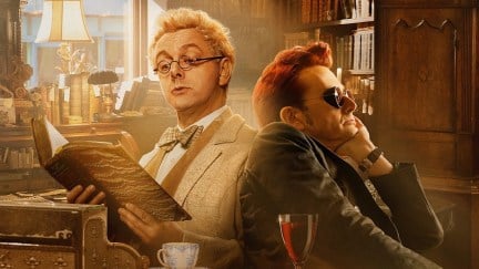 Aziraphale and Crowley sit back to back in Aziraphale's bookshop. Aziraphale is reading a book while Crowley stares into the distance.