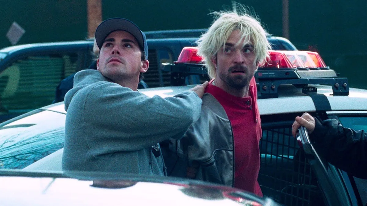 Connie Nikas (Robert Pattinson) gets led into a police car by a plainclothes cop in "Good Time"