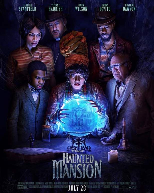 A poster for Disney's Haunted Mansion, showing a group of people all leaning over a glowing crystal ball. Various occult items are placed on the table in front of them, including a white sage bundle in an abalone shell.