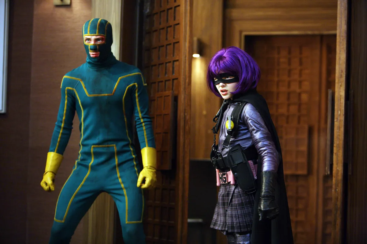 Costumed vigilantes Kick-Ass and Hit Girl preparing to fight in "Kick Ass"
