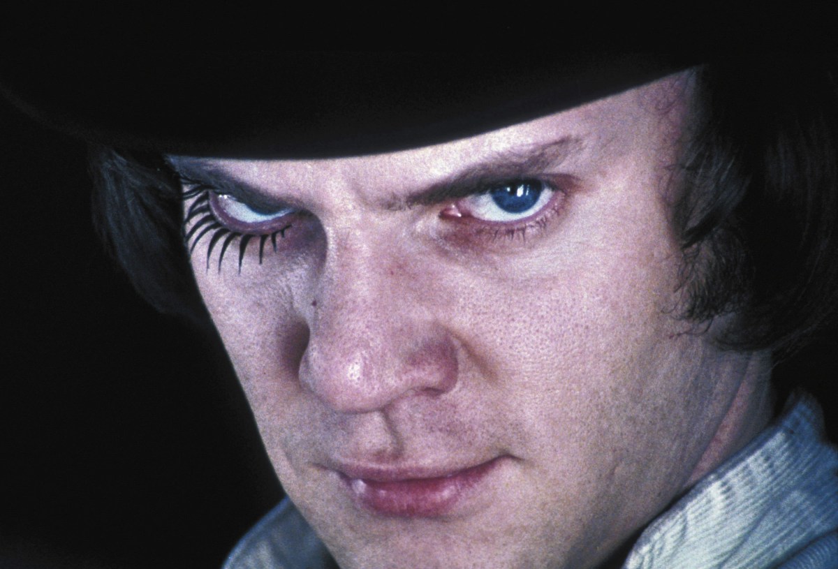 A white man staring into the camera intensely with spider like eyelashes in "A Clockwork Orange"