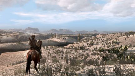 A man on horseback overlooking a desert in the game Red Dead Redemption.