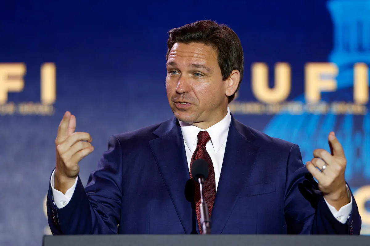 Ron DeSantis speaks and gestures from a podium.