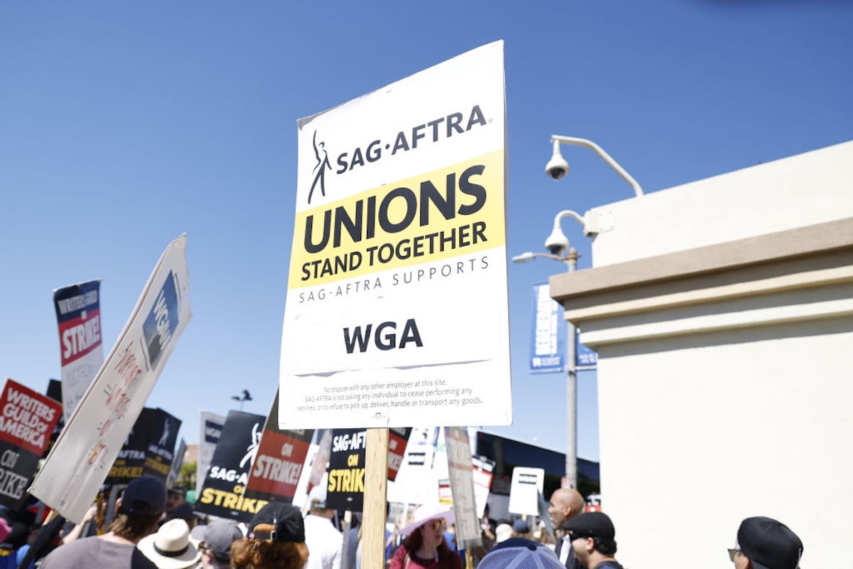 A picket sign reads, "SAG-AFTRA Unions Stand Together."