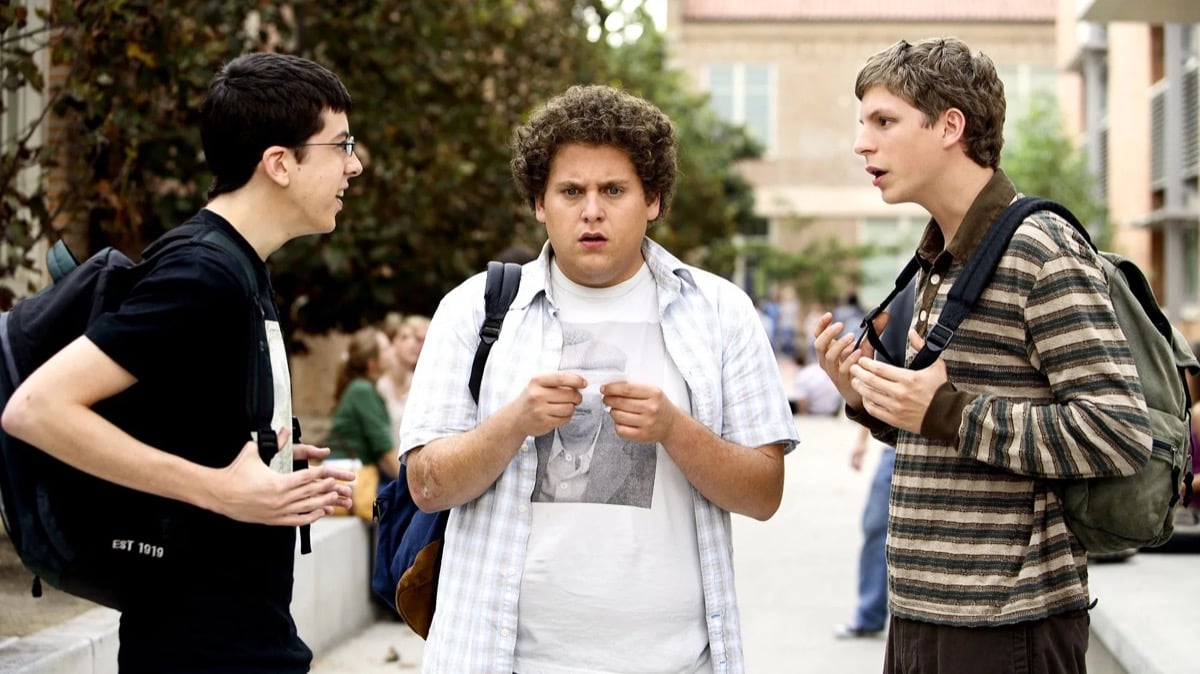 Three teenage boys talk to each other after school in "Superbad"