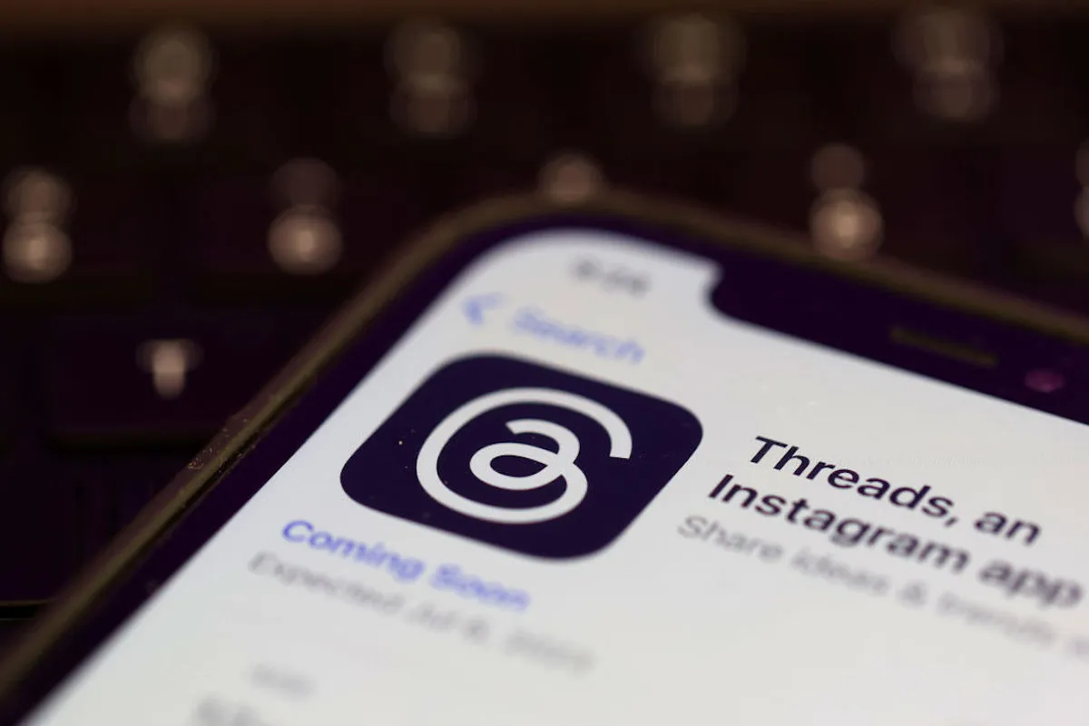 A photo illustration shows the Threads app in the app store on a cell phone