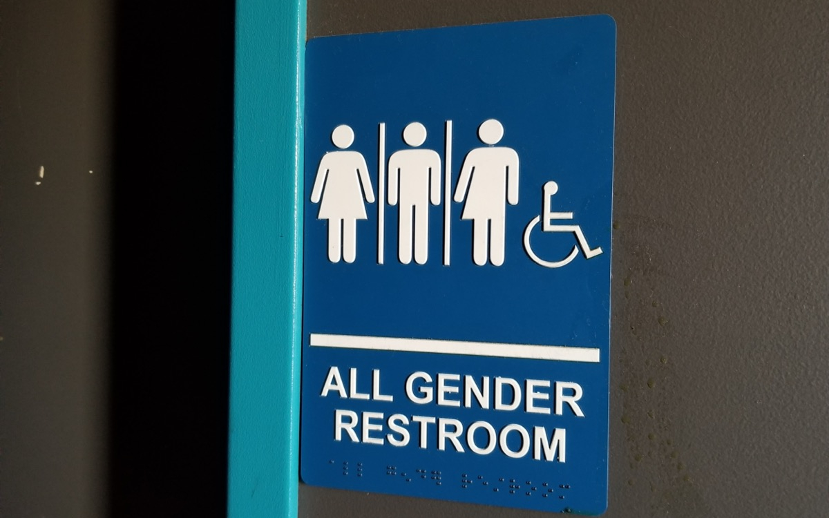 Close-up of sign for all gender restroom. (Smith Collection/Gado/Getty Images)