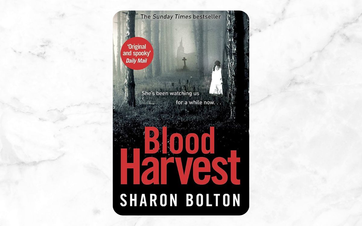 A small girl in a white dress walks in a graveyard on the cover of "Blood Harvest"