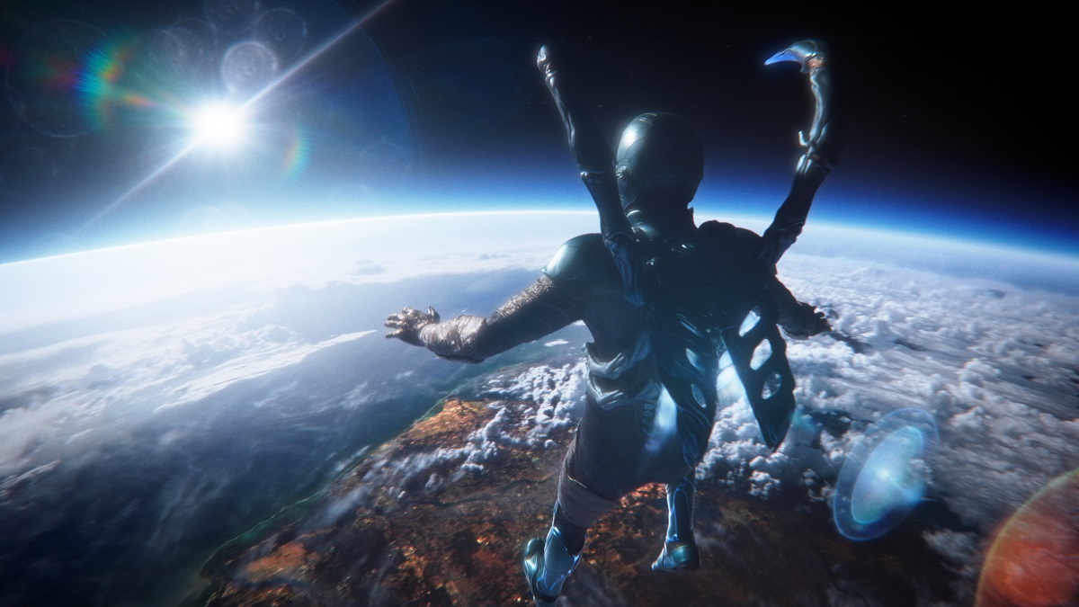 Image of Jaime Reyes in the Blue Beetle suit as he hovers in orbit over the earth in a scene from the live-action 'Blue Beetle' film starring Xolo Maridueña.