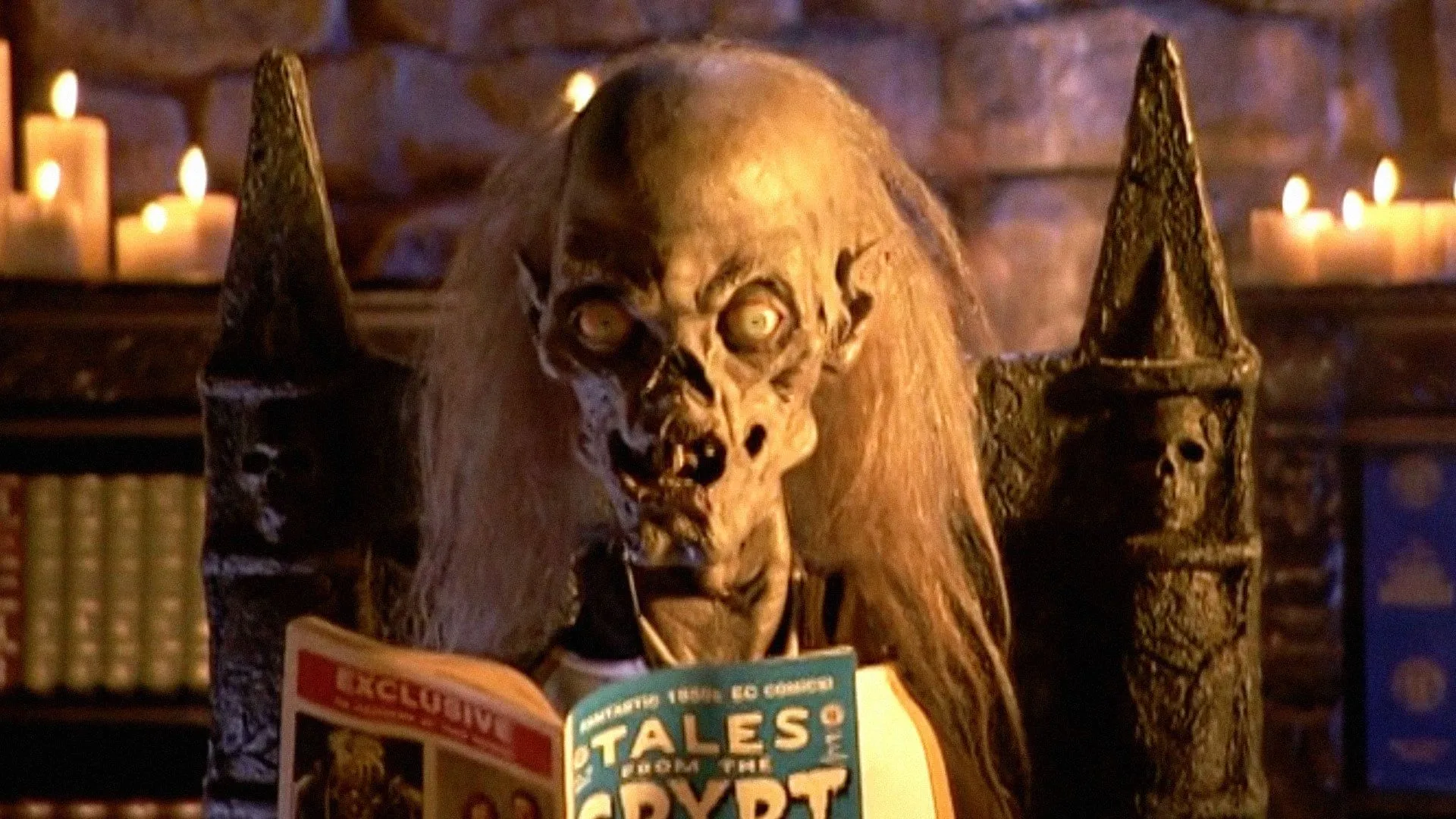 A skeletal Cryptkeeper reads from an EC comic book in 'Tales From the Crypt.'