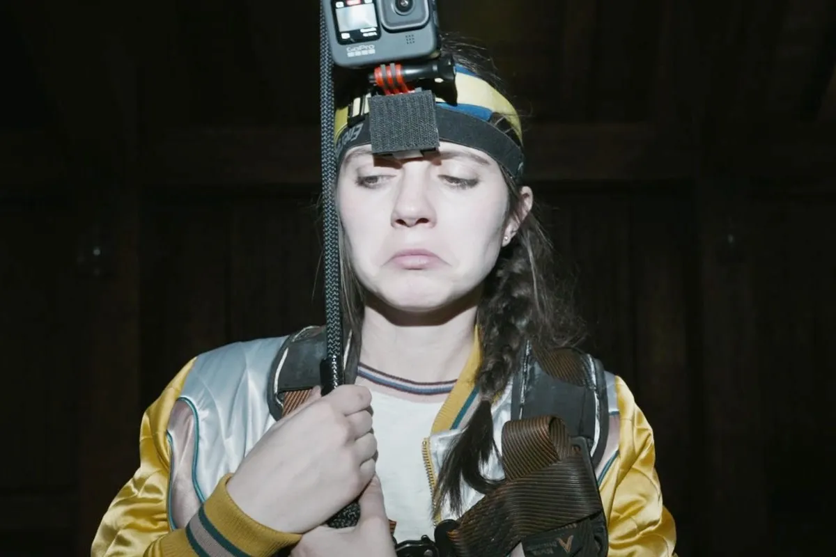 Margot (Emily Bader) wearing a Go Pro and looking weirded out in Paranormal Activity: Next of Kin