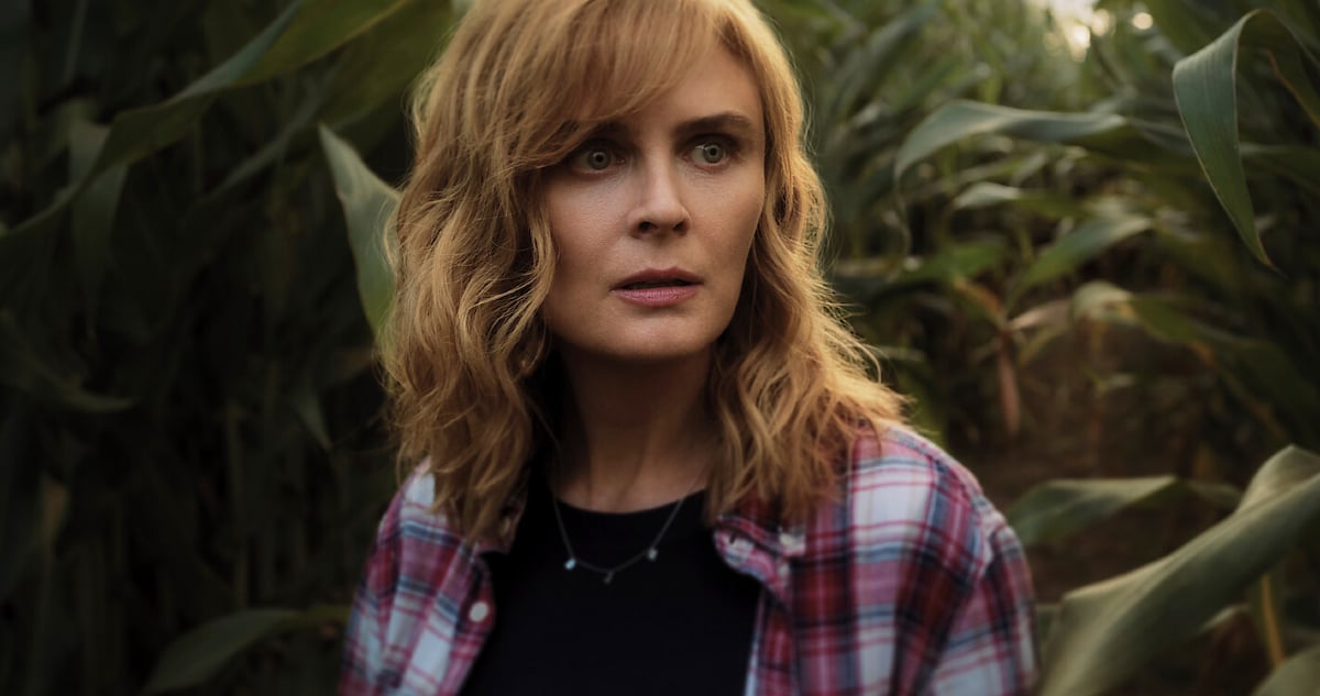 Emily Deschanel in 'Devil in Ohio.' A woman stands in a cornfield looking concerned. 