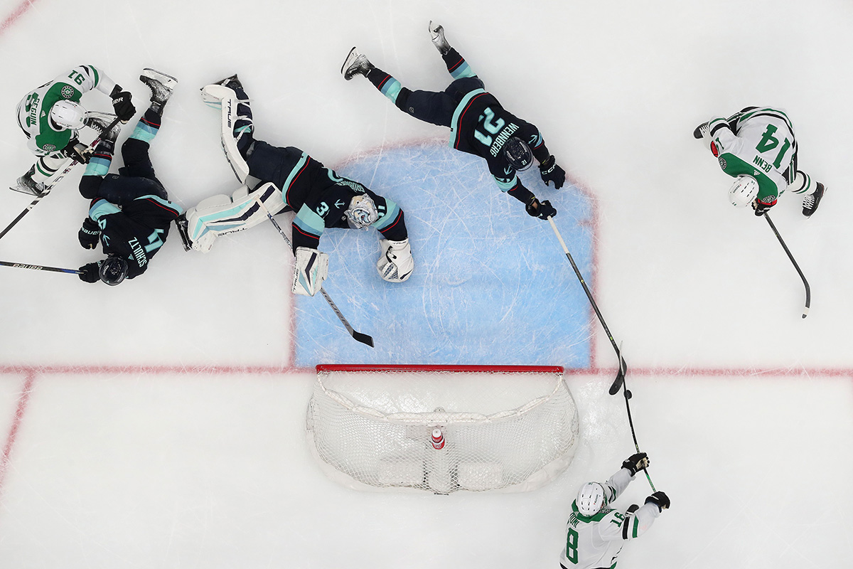 SEATTLE, WASHINGTON - MAY 09: Alex Wennberg #21 of the Seattle Kraken deflects the puck from Max Domi #18 of the Dallas Stars during the second period in Game Four of the Second Round of the 2023 Stanley Cup Playoffs at Climate Pledge Arena on May 09, 2023 in Seattle, Washington. (Photo by Steph Chambers/Getty Images)