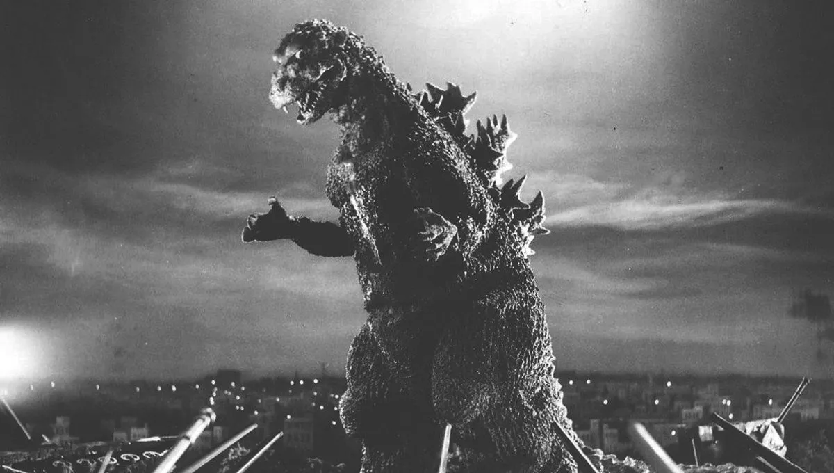 Godzilla, a giant lizard-monster, stomps around a city in a black-and-white still from 1954's 'Godzilla'