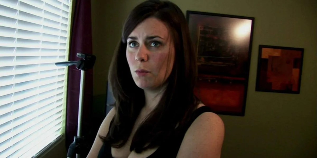 Katie (Katie Featherston) looking perplexed at her boyfriend in Paranormal Activity