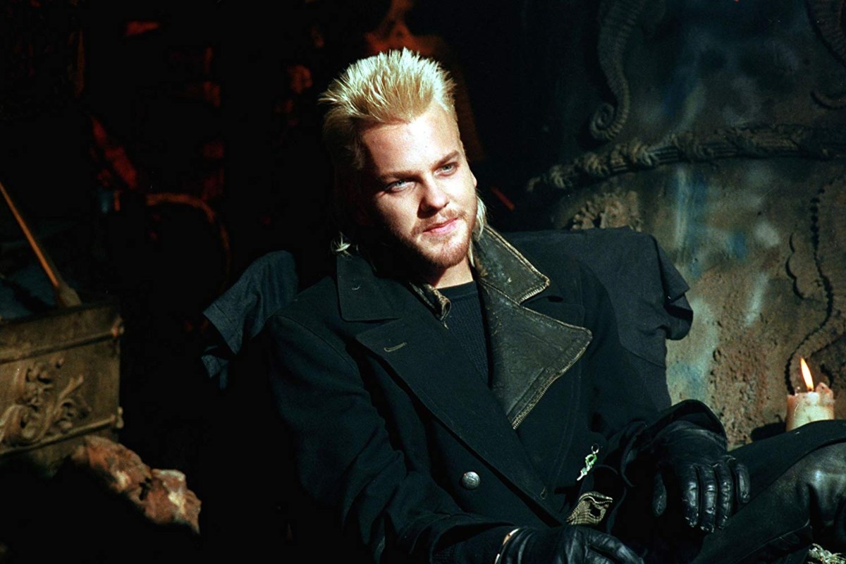 A blonde vampire named David (Kiefer Sutherland) smiling in 'The Lost Boys'