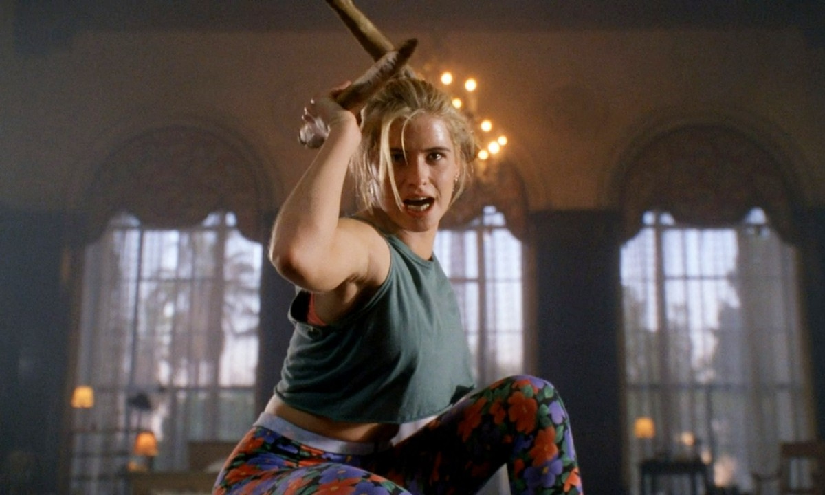 A teenage girl named Buffy Summers (Kristy Swanson) holding a stake in the film 'Buffy the Vampire Slayer'