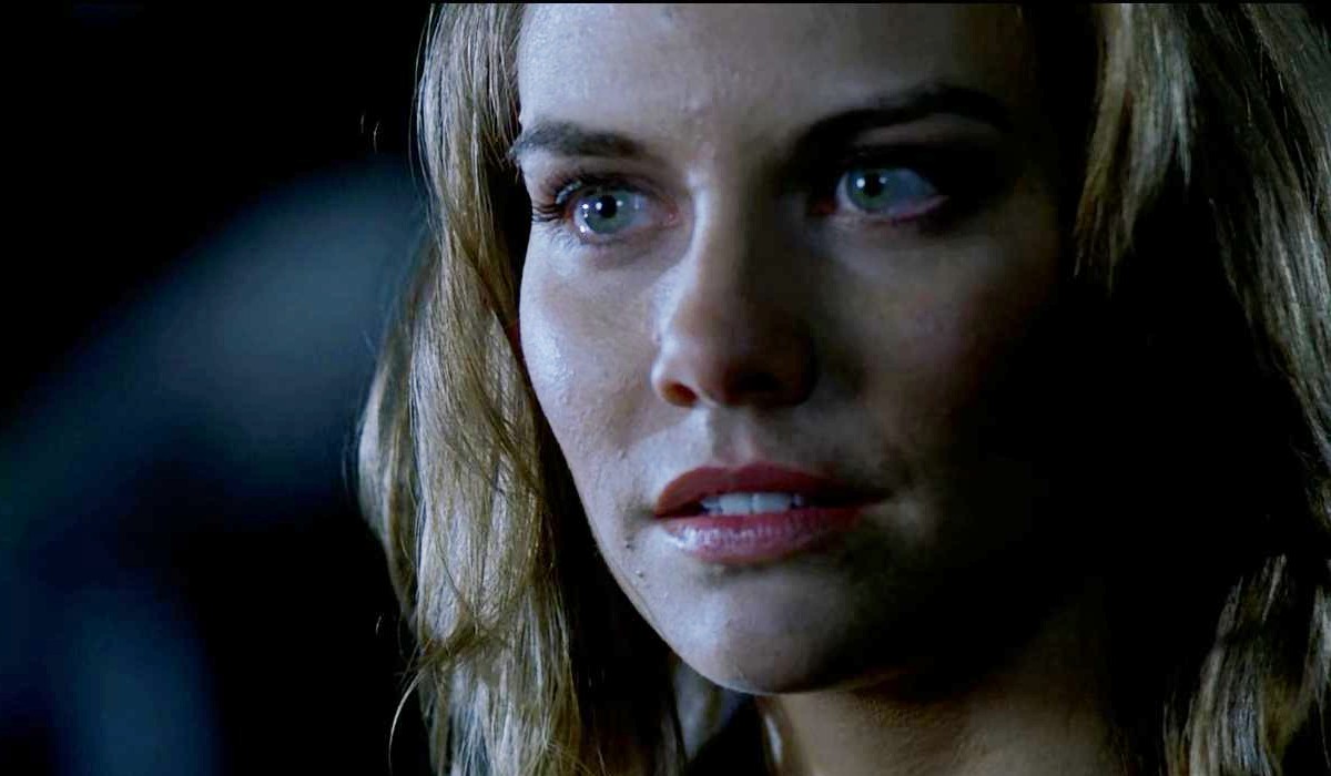 A woman with striking green eyes being mysterious in "Supernatural"