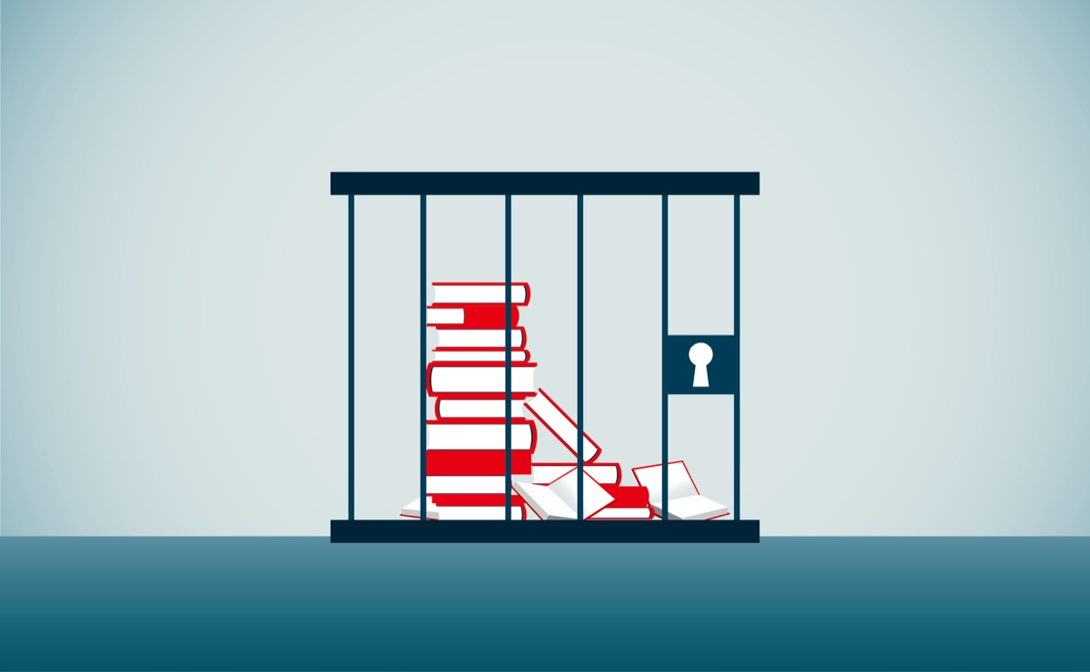 A stack of books locked up in a jail cell