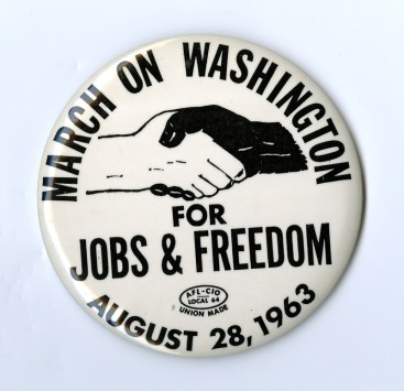 Button "March on Washington for Jobs & Freedom August 28, 1963" around a design of black and white hands shaking.