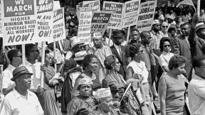 The March on Washington - Marchers gathering at the Lincoln Memorial after walking from Washington Monument grounds. The image depicts a crowd of people marching, holding up placard that read 