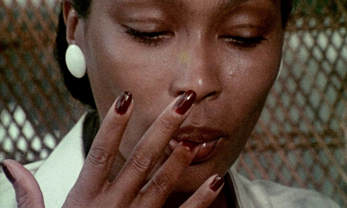 A dark skinned black woman named Ganja Meda (Marlene Clark) licking her finger in 'Ganga & Hess'