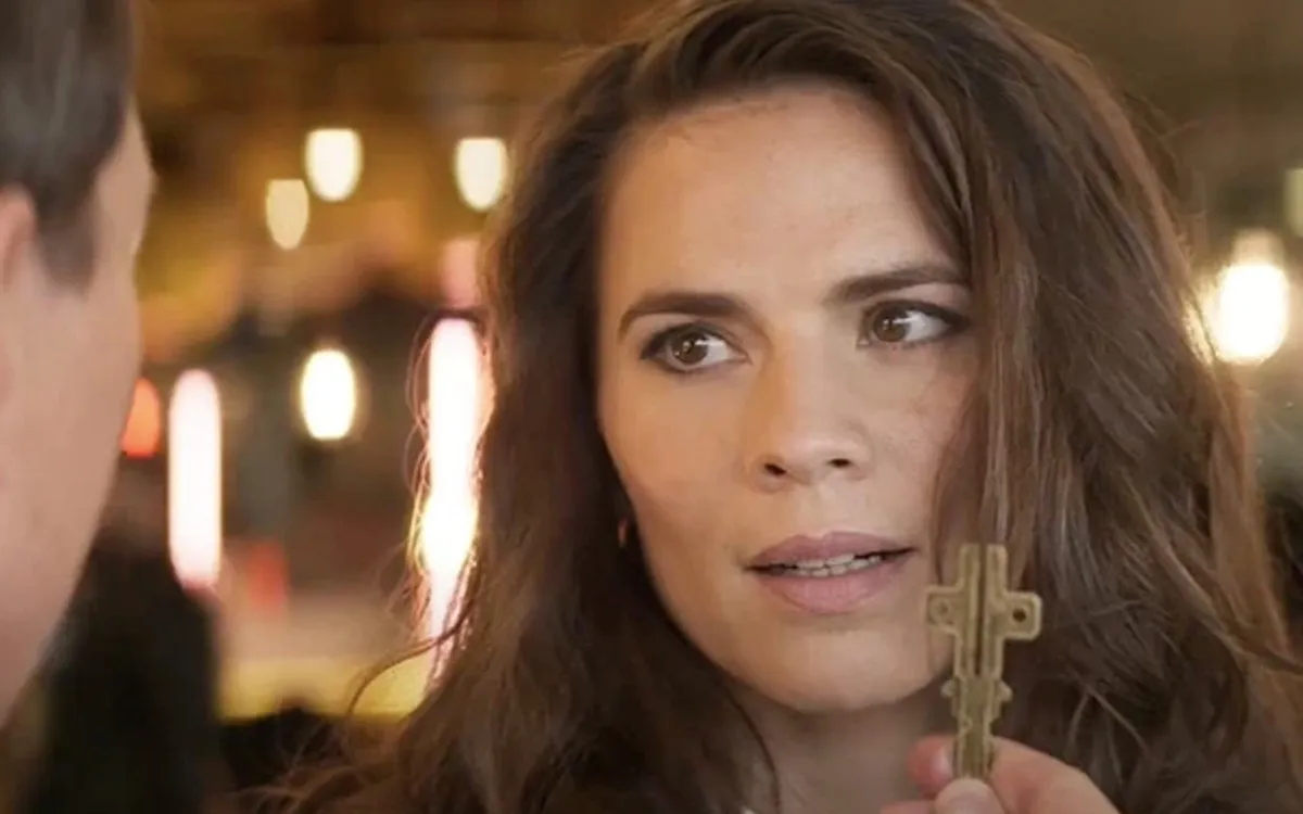Hayley Atwell as Grace in Mission: Impossible – Dead Reckoning Part One, as Ethan holds the cruciform key up in front of her face.
