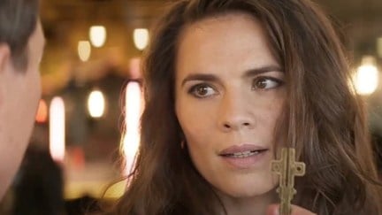 Hayley Atwell as Grace in Mission: Impossible – Dead Reckoning Part One, as Ethan holds the cruciform key up in front of her face.