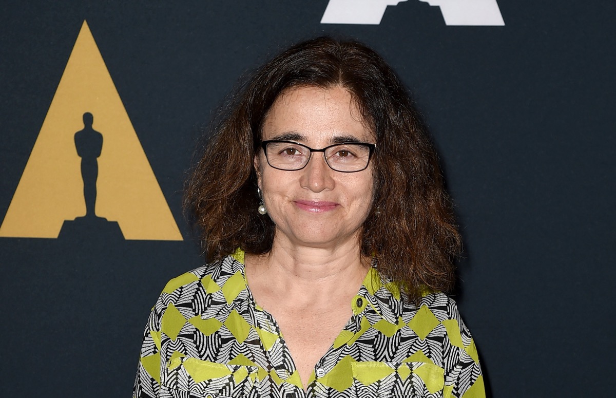 Patricia Cardoso standing in front of an Academy Awards-themed press photo background.