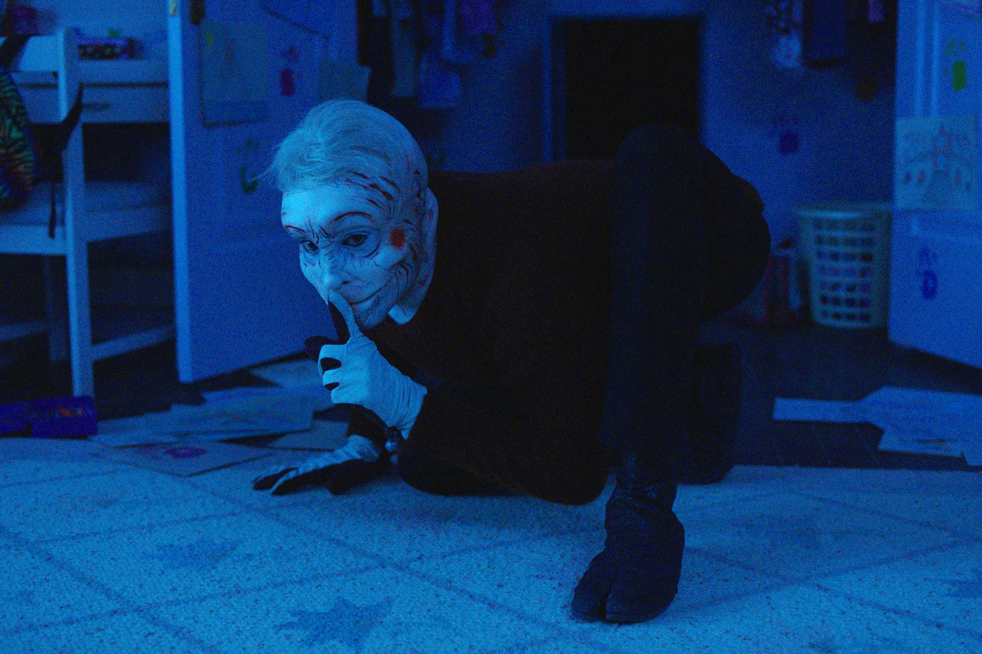 A clown-faced man named Pretzel Jack (Troy James) crouches on the floor of a dark kitchen in 'Channel Zero.'