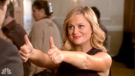 Amy Poehler smiling and giving two thumbs up as Leslie Knope in Parks and Recreation.