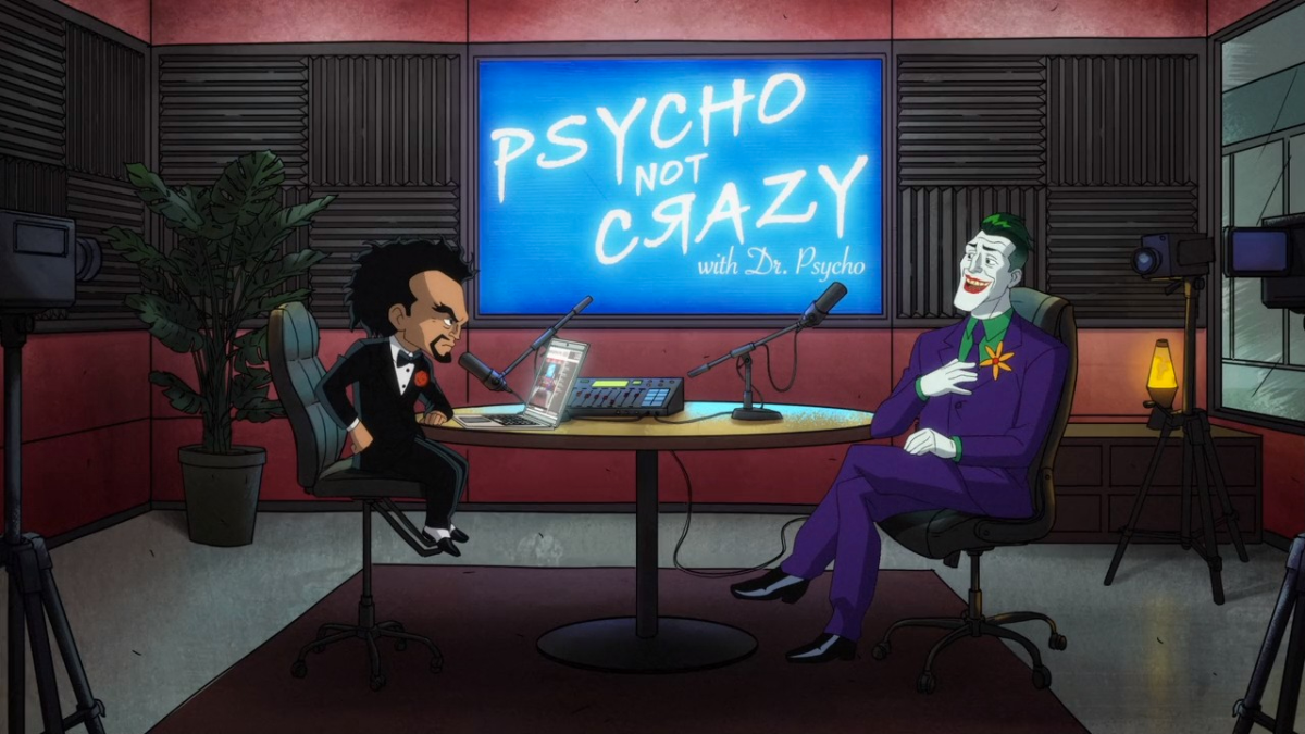 Dr. Psycho sitting across the table talking to The Joker in his new podcast.